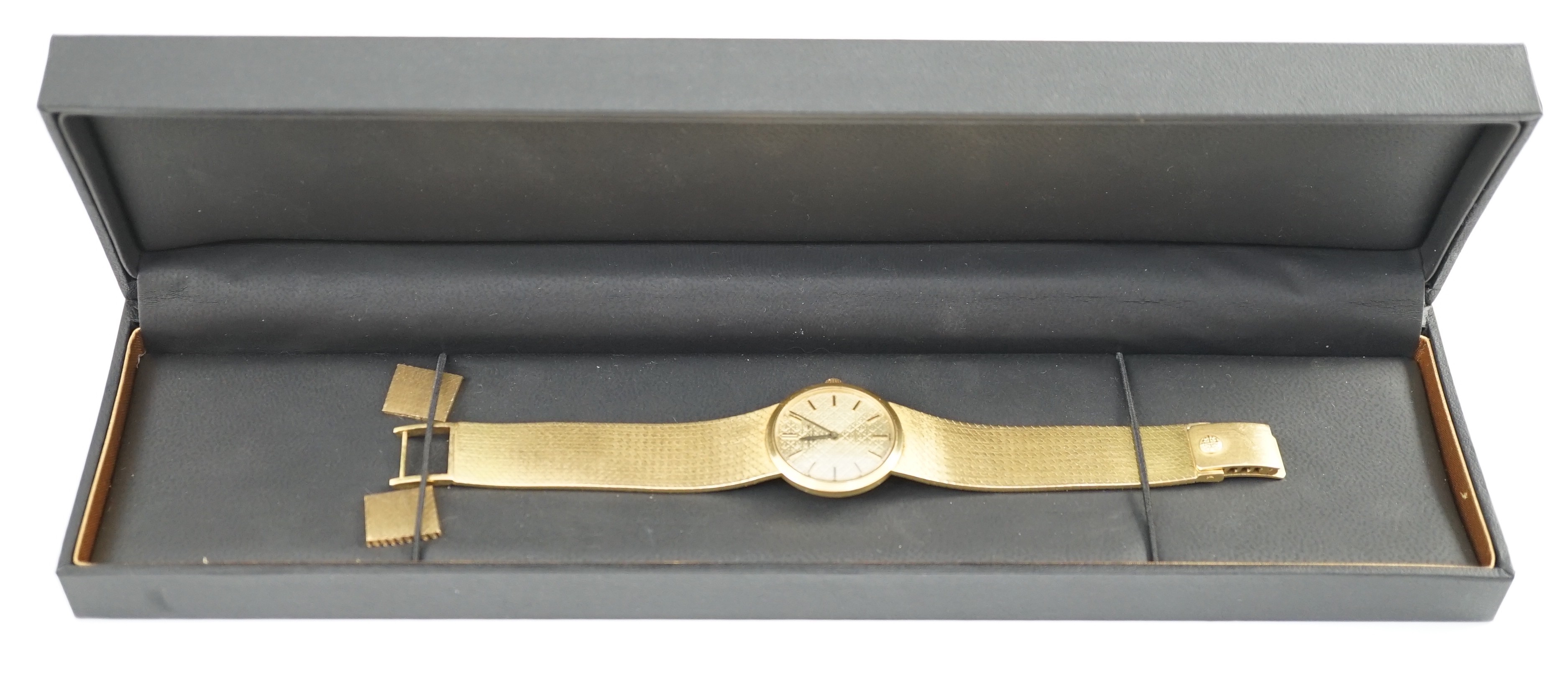 A lady's 18ct gold Patek Philippe manual wind wrist watch, on an integral 18ct gold Patek Philippe bracelet